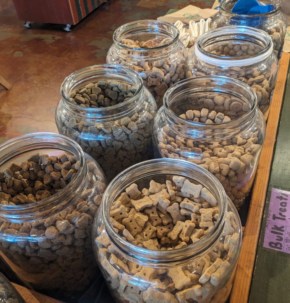 Two lines of glass jars filled with bulk baked dog cookies