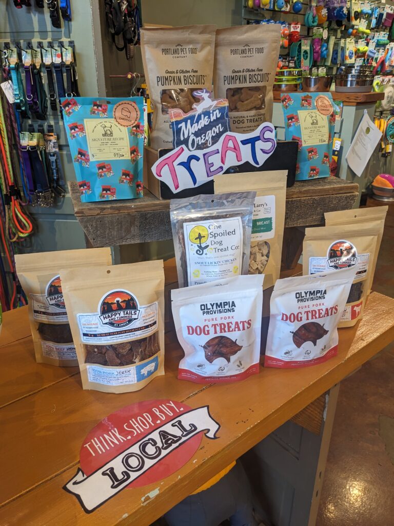 Table display of various treats made locally including bags of Bring!, Olympia Provisions, Happy Tails and Tummies, Portland Pet Food, and One Spoiled Dog.