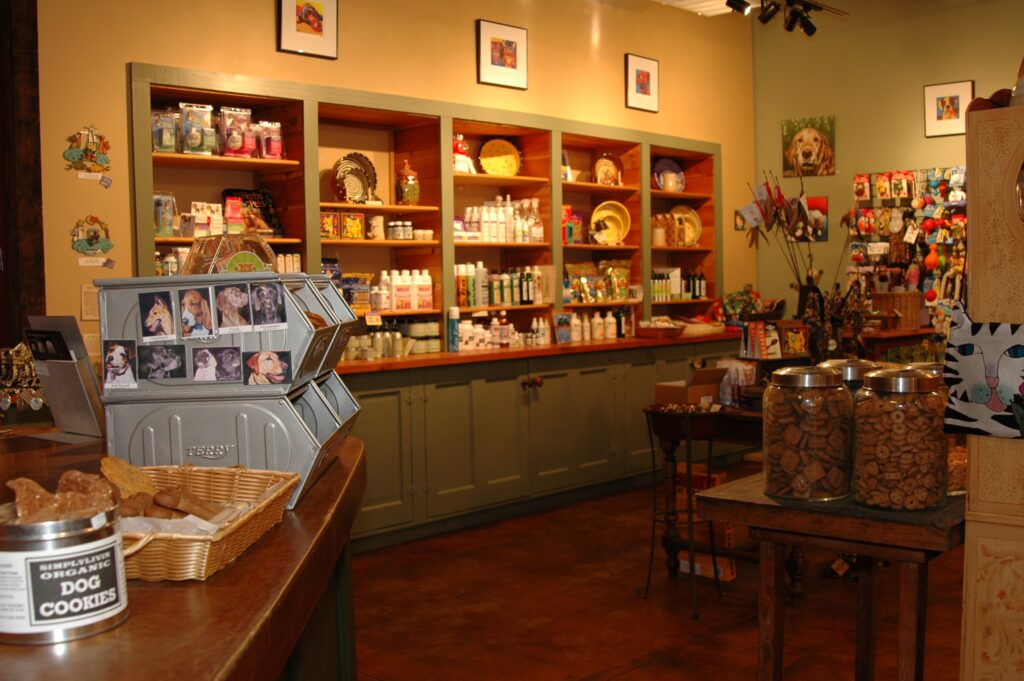 Light green shelving is built into a beige wall, filled with sustainable pet supplies